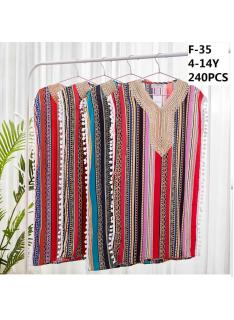Girls kaftan dress with multicolor striped print, decorative neckline and pom-pom trims.